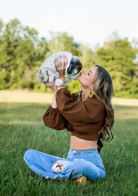 High school senior in Callahan, lifts her pet bunny close while her guinea pig rests in her lap, blending personality and connection in a meaningful outdoor senior. photo session - A portrait experience by Nature's Child Photography.