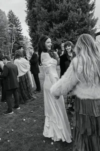 Bride mingling with wedding guests during cocktail hour in the Marble Garden at Aspen Meadows Resort in Aspen, Colorado.