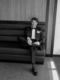 Groom in a black tuxedo seated before his wedding at Aspen Meadows Resort in Aspen, Colorado.