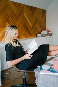 sasha looking at book, feet up