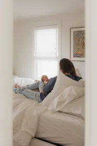 dad-newborn-bedroom-doorway-natural-light-editorial-in-home-boulder-70