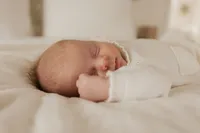 newborn-sleeping-white-knit-fist-cheek-in-home-boulder-photographer-366