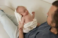 dad-newborn-chest-cream-sofa-looking-down-in-home-boulder-photographer-199