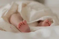 newborn-baby-feet-peeking-muslin-blanket-in-home-boulder-photographer-28