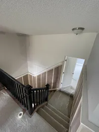 Staircase with Wainscoting getting prepped for painting in Wayzata.