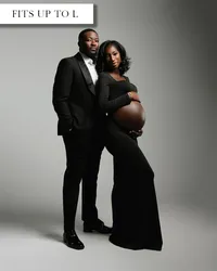Black maternity outfit with a long-sleeved scoop-neck crop top and fitted floor-length skirt worn below the belly.