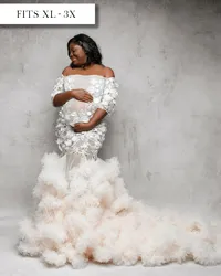 Fitted sheer tulle white maternity dress with flower embellishments and three quarter length sleeves with ruffles in mermaid shape.