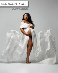 White maternity gown with a twisted off-the-shoulder bodice, open belly, high leg opening, and flowing train.
