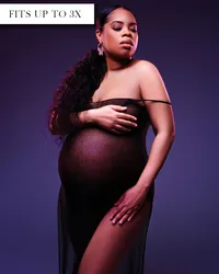 Sheer black maternity gown with thin off-the-shoulder straps, a fitted silhouette, and a high leg opening.
