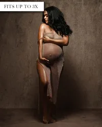 Sheer taupe maternity gown with a strapless neckline, close-fitting silhouette, and a high opening over one leg.