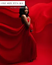 Red maternity gown with a strapless neckline, fabric draped over the belly, and a wide train flowing behind