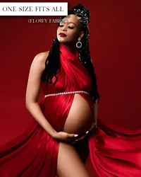 Red maternity wrap with a halter neckline, open belly, draped skirt, and jeweled belt beneath the bust.