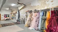 Client closet featuring maternity gowns in cream, blush, lavender, blue, green, yellow, and burgundy.