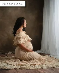 Cream off-the-shoulder maternity dress with eyelet lace ruffles over the chest and flowy pleated layers.