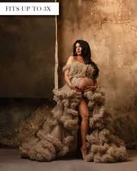 Cream maternity gown with an off-the-shoulder ruffled bodice, open belly, high slit, and tiered ruffled train.