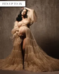Beige maternity gown with a sweetheart bodice, sheer puff sleeves, open belly, and tiered skirt with a long train.