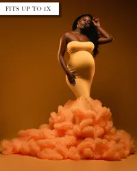 Fitted golden yellow mermaid style strapless maternity gown with empire waist and ruffles along trumpet shaped bottom.
