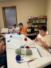 kids learning to knit in class