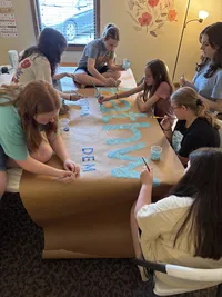 kids making pathway sign together