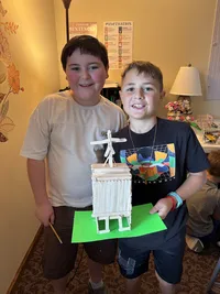 boy showing craft made in class