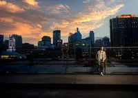 High school senior in a tailored suit photographed on a downtown Minneapolis street at night by Megan Engeseth Photography