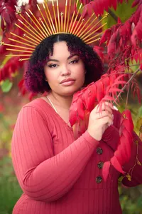 Creative senior portrait in Minneapolis studio with dramatic lighting and confident pose