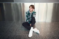 Minneapolis senior pictures of a high school girl sitting on concrete steps in a trendy outfit by Megan Engeseth Photography