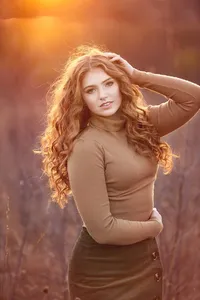 Senior portrait capturing a creative teen in the fall outside with cinematic lighting and mood