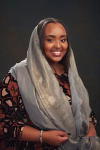 Somali Senior girl in studio with glowing rim light and cinematic mood