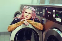 Senior Picture Photographer Captures Fun Lifestyle Portrait in Urban Laundry Setting-14