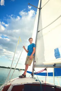 Sailing senior pictures on the water capturing personality and lifestyle with natural light