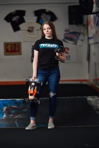 girl holding Remote control car posing for senior pics in Minnesota
