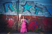 Twin Cities senior portrait photographer capturing a teen in motion on a downtown Minneapolis sidewalk by Megan Engeseth Photography