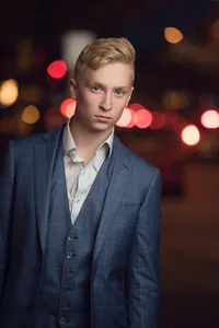 Artistic urban senior portrait of a teen against a geometric painted wall in Minneapolis by Megan Engeseth Photography