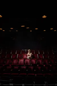 Woman Alone in Theater Seats-13