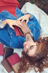 Unique senior picture showcasing individuality and expressive movement with books