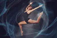 Dancer jumping with swirls and grace in St. Paul Senior portrait studio