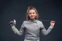 Fencing senior pictures with athletic gear and bold confident posing by Minneapolis photographer
