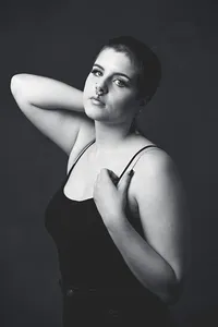 Studio portrait featuring a girl laughing in bright, clean light