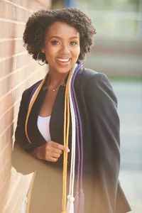 senior picture of a college graduate in cap and gown