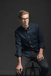 Senior portrait photographed in St. Paul studio with dramatic controlled lighting and cinematic mood