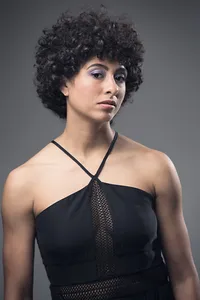 Studio senior portrait on seamless white backdrop with fashion-inspired styling in St. Paul