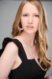 Senior photographed in a studio with soft shadow gradients