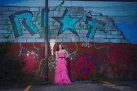 Senior portrait of a high school girl sitting on a fire escape in an urban Minneapolis neighborhood by Megan Engeseth Photography
