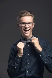 Senior photographed in studio with crisp, modern styling