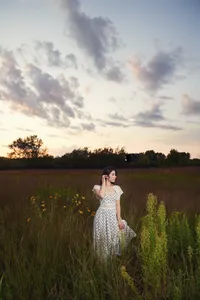 senior boy portrait in open field Minnesota golden hour