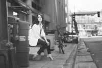 High school senior photographed at night in downtown St. Paul with bokeh city lights in the background by Megan Engeseth Photography