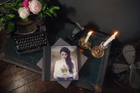 Portrait product samples displayed in studio showing albums mats frames and wall art options
