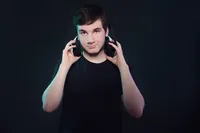 Senior guy holding his headset playing vidoegames