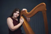enior portrait of a harpist with elegant styling and expressive performance pose in Minneapolis